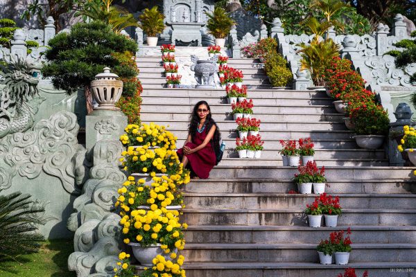 Tourist in Vietnam at staircase of a pagoda