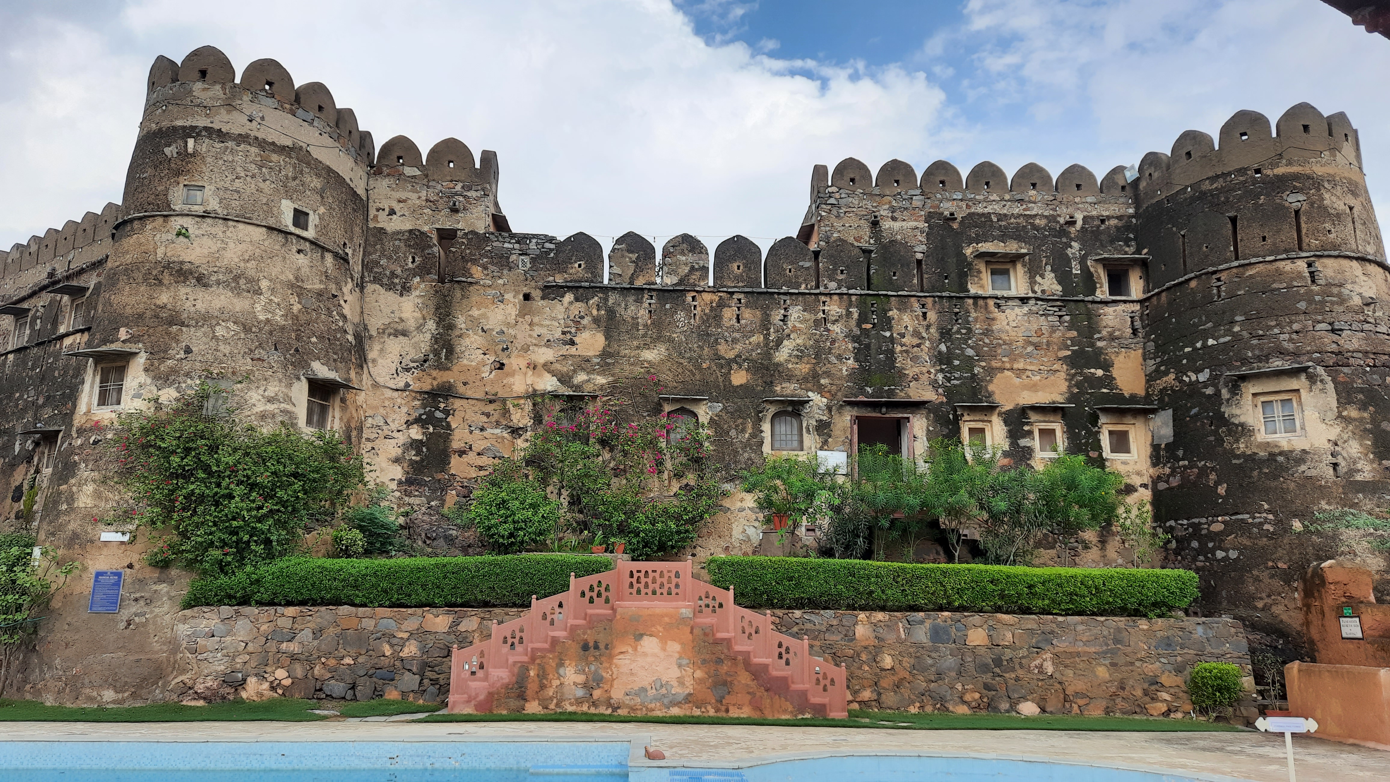 View of a heritage fort hotel with pool backdrop