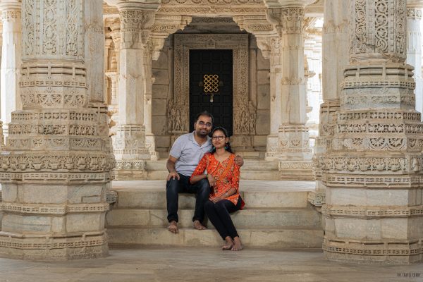Couple sitting between marble pillars inside a temple