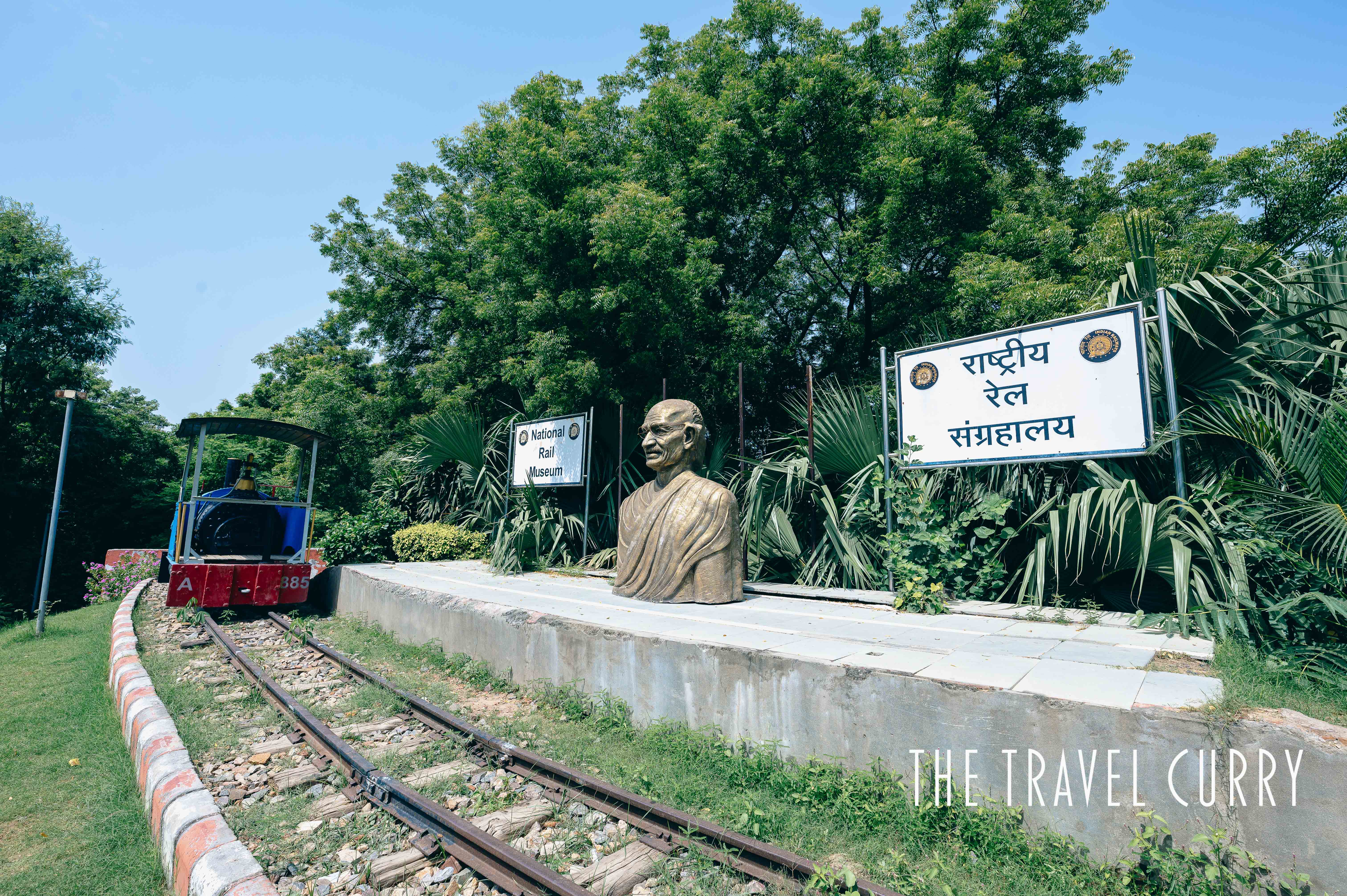 Gandhi statue with the name board at Delhi's National Rail Museum