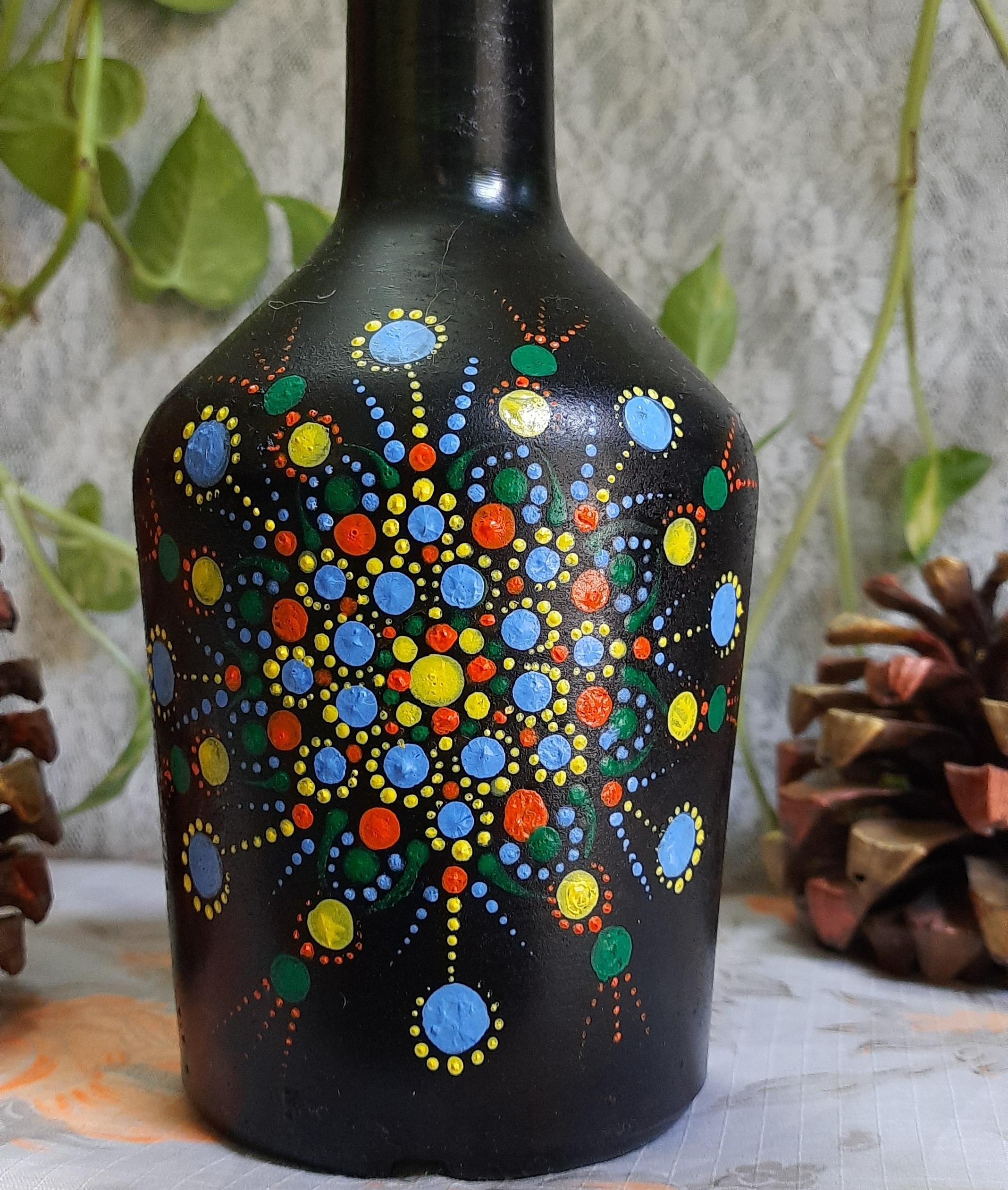 Black bottle styled with mandala dots 
